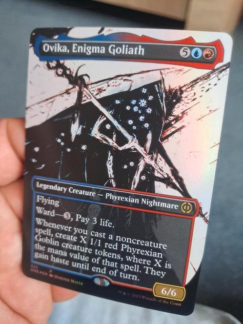 Ovika enigma  Goliath foil 2023 NM/MINT Engels, Hobby en Vrije tijd, Verzamelkaartspellen | Magic the Gathering, Zo goed als nieuw