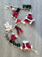 Drie kerstslingers 'kledij van de kerstman', Ophalen