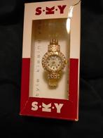 Armbandhorloge voor dames,bezet met gekleurde steentjes., Neuf, Avec strass, Enlèvement ou Envoi, Or