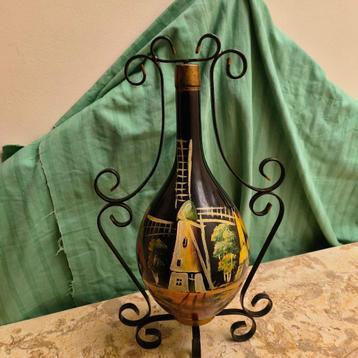 Vintage stenen fles op ijzeren staander beschikbaar voor biedingen