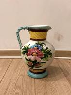 Vaasje met bloemen op, Ophalen