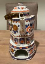 Theepot met kaarsbrander, Ophalen