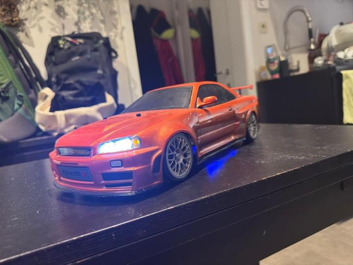 Tamiya Nissan Nismo R34 GT-R Z-tune 4WD TT-02D RTR, Hobby en Vrije tijd, Modelbouw | Radiografisch | Auto's, Zo goed als nieuw