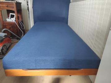 Eenpersoonsbed, blauwe stoffen basis, houten structuur. beschikbaar voor biedingen