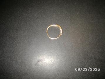 Een goudkleurige ring met verscheidene steentjes beschikbaar voor biedingen