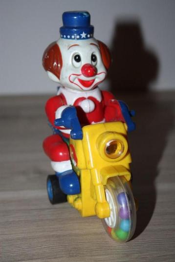 Opwindbare clown motorfiets , ogen+voeten gaan op en neer beschikbaar voor biedingen