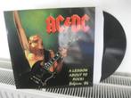 AC/DC - A LESSON ABOUT TO ROCK - BELGIUM '86, Ophalen of Verzenden