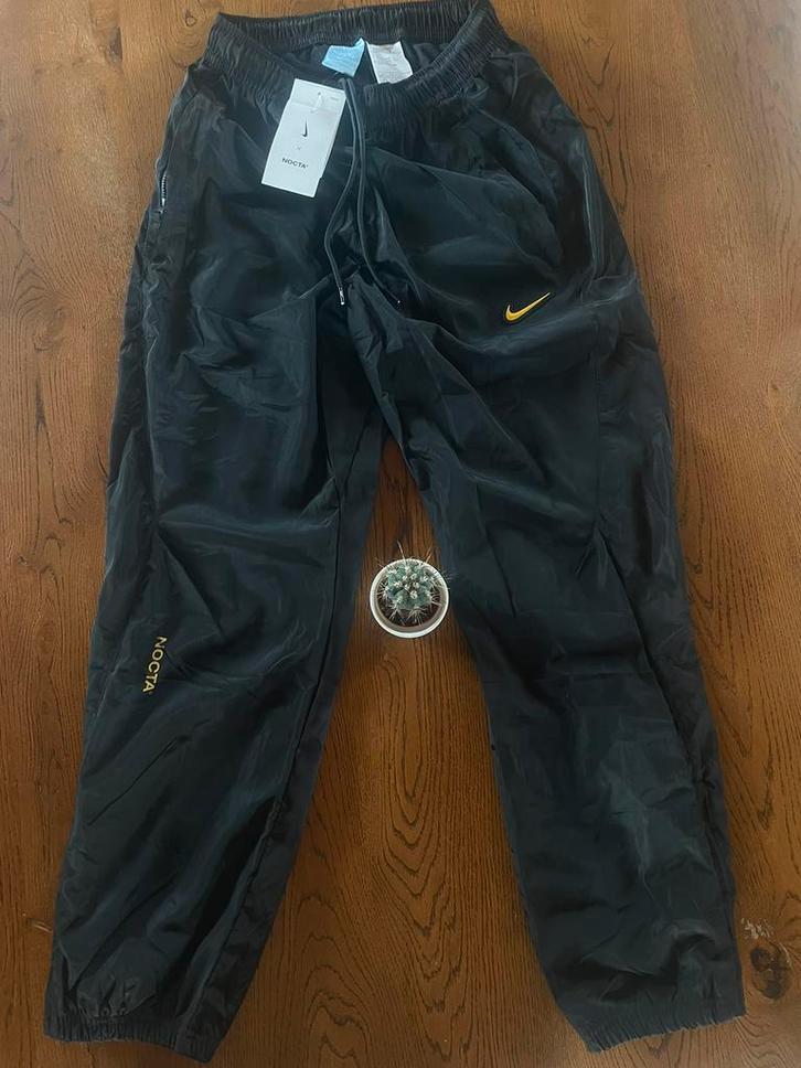 trainingsbroek Nocta x Nike, Kleding | Heren, Broeken en Pantalons, Nieuw, Maat 46 (S) of kleiner, Zwart, Ophalen of Verzenden