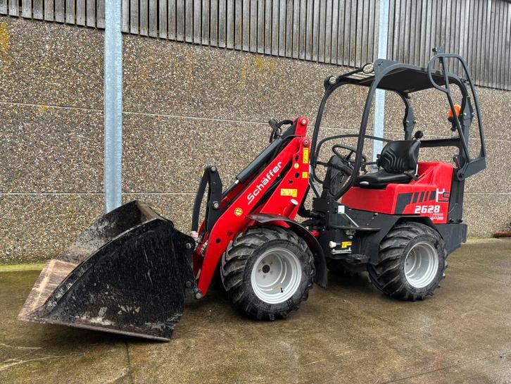 Kniklader Schaffer 2628 in nieuwstaat met bak en lepels, Zakelijke goederen, Machines en Bouw | Kranen en Graafmachines, Wiellader of Shovel