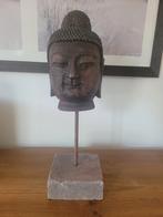 Tête de Bouddha sur socle, Enlèvement ou Envoi