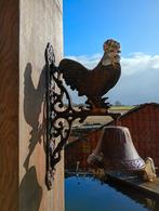 Gietijzeren bel met kip, Ophalen