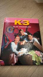 K3 en de verkleedkoffer, Enlèvement