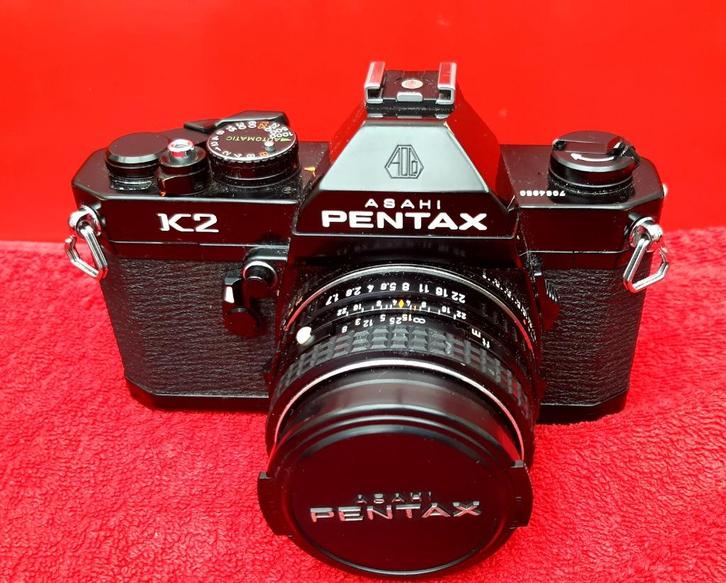 Foto toestel Pentax K met zwarte body, telelens en groot hoe, Verzamelen, Foto-apparatuur en Filmapparatuur, Fototoestel, 1960 tot 1980