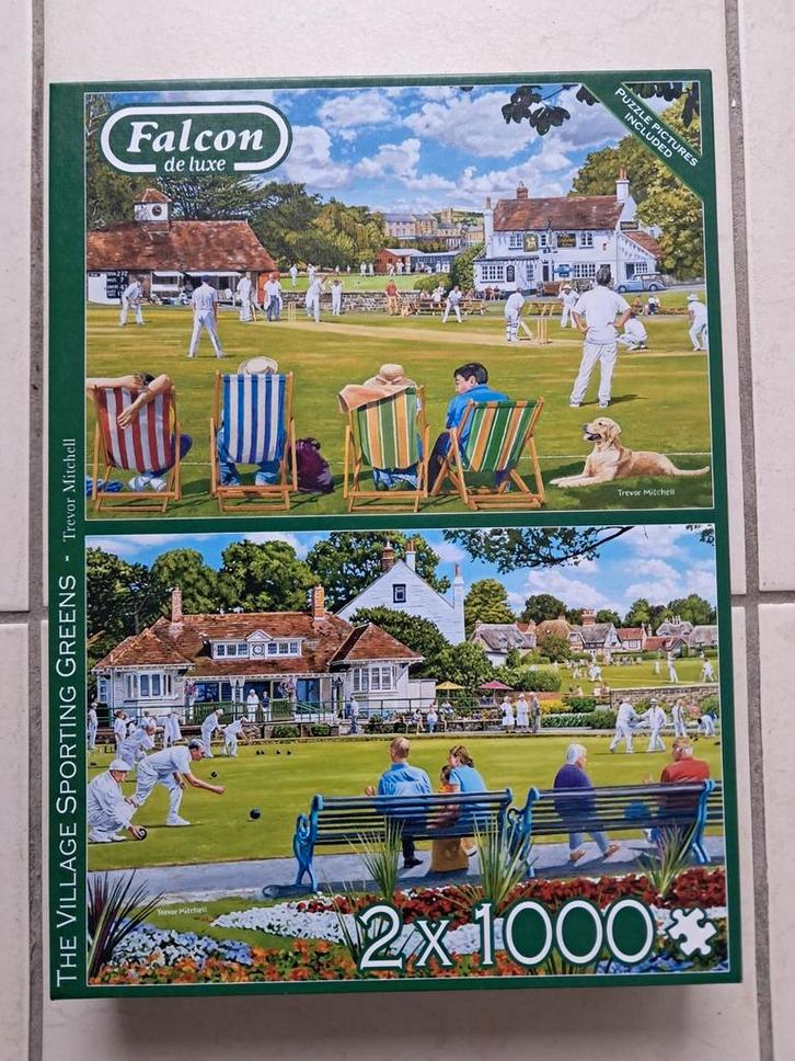 Puzzelbox 2 x 1000 stukjes- The Village sporting greens, Hobby en Vrije tijd, Denksport en Puzzels, Gebruikt, Legpuzzel, 500 t/m 1500 stukjes