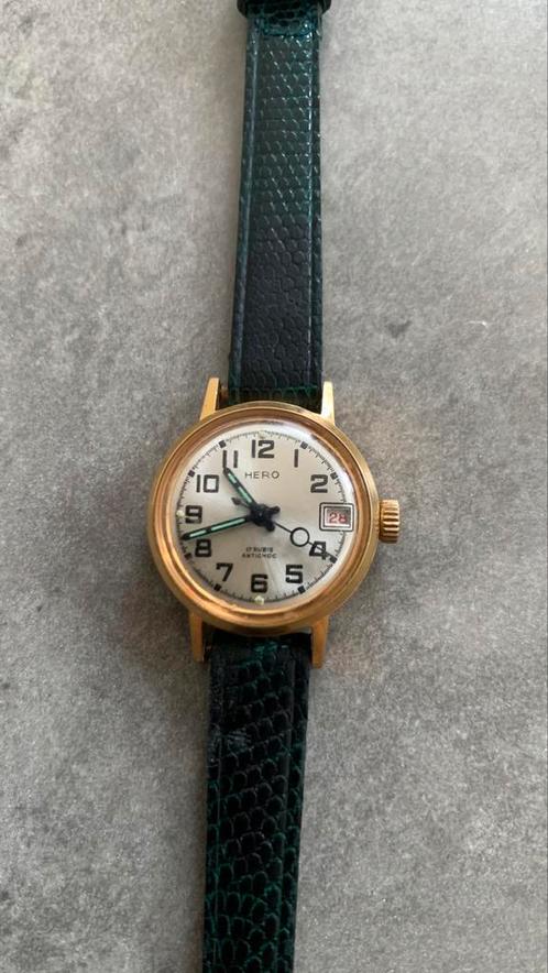 Mechanical Hero-horloge met datum (te herzien), Handtassen en Accessoires, Horloges | Dames, Goud, Goud, Ophalen of Verzenden
