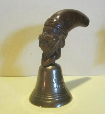 Antieke bronzen bel met handgesneden houten hoofd  beschikbaar voor biedingen