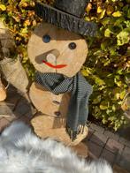 Houten sneeuwmannen, Ophalen