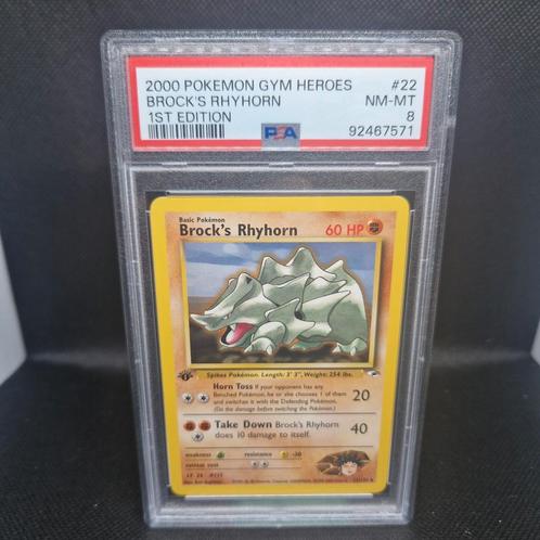 Brock's Rhyhorn 1st Edition Gym Heroes PSA 8, Hobby en Vrije tijd, Verzamelkaartspellen | Pokémon, Zo goed als nieuw, Ophalen of Verzenden