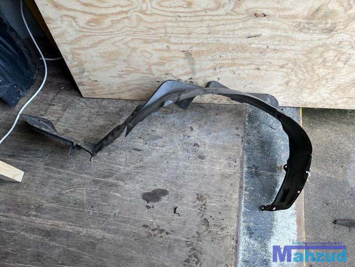 2005 MITSUBISHI LANCER 7 links voor modderkuip 2003-2007, Auto-onderdelen, Carrosserie, Bumper, Mitsubishi, Gebruikt, Ophalen of Verzenden