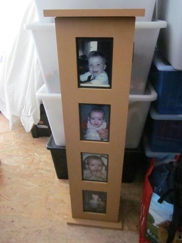 Een kastje met 5 plankjes en de deuropening met foto's
