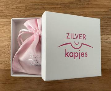 Zilveren tepelkapjes