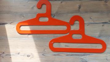 Typische vintage 2 oranje plastic hangers beschikbaar voor biedingen