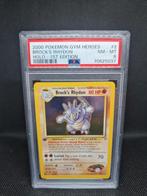 Brock's Rhydon Holo 1st Edition Gym Heroes PSA 8, Hobby en Vrije tijd, Verzamelkaartspellen | Pokémon, Ophalen of Verzenden, Zo goed als nieuw