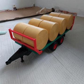 Bruder wagen + 8 balen beschikbaar voor biedingen