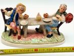 Porseleinen beeldje van twee mensen aan een tafel, Ophalen