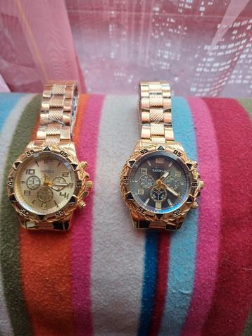 2 nieuwe horloges van goudkleurig metaal.  beschikbaar voor biedingen