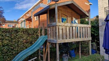 Houten speelhuisje met glijbaan. Speelhuis beschikbaar voor biedingen
