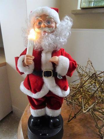 Kerstman met muziek, kaarsje brandt, hoofd en arm bewegen  beschikbaar voor biedingen