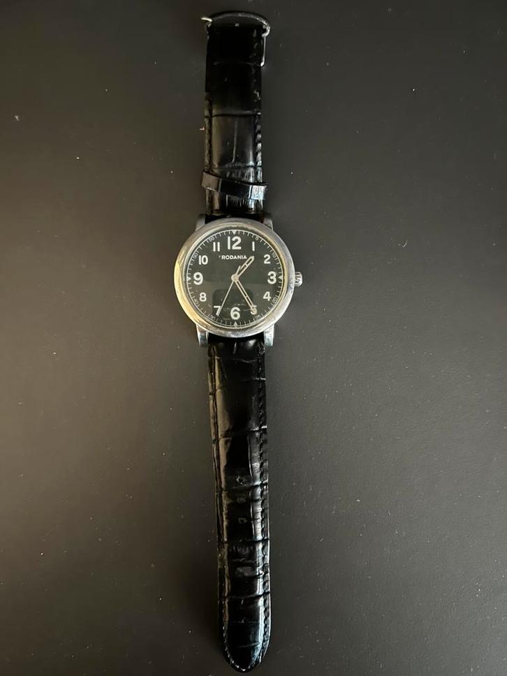 Rodania Herenhorloge – Quartz – Zwarte Wijzerplaat, Handtassen en Accessoires, Horloges | Dames, Zo goed als nieuw, Ophalen