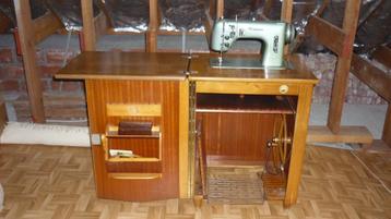 Zeer oude naaimachine met ondermeubel beschikbaar voor biedingen