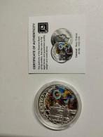 Een sterling zilveren munt over de carnaval en gekleurde tek, Ophalen