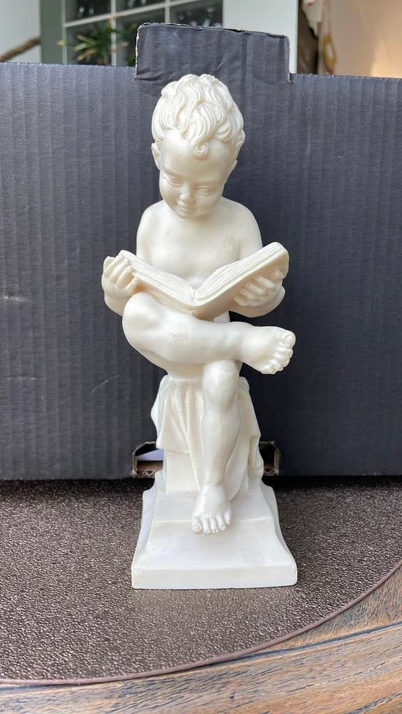 Beeldje lezend jongetje, Ophalen