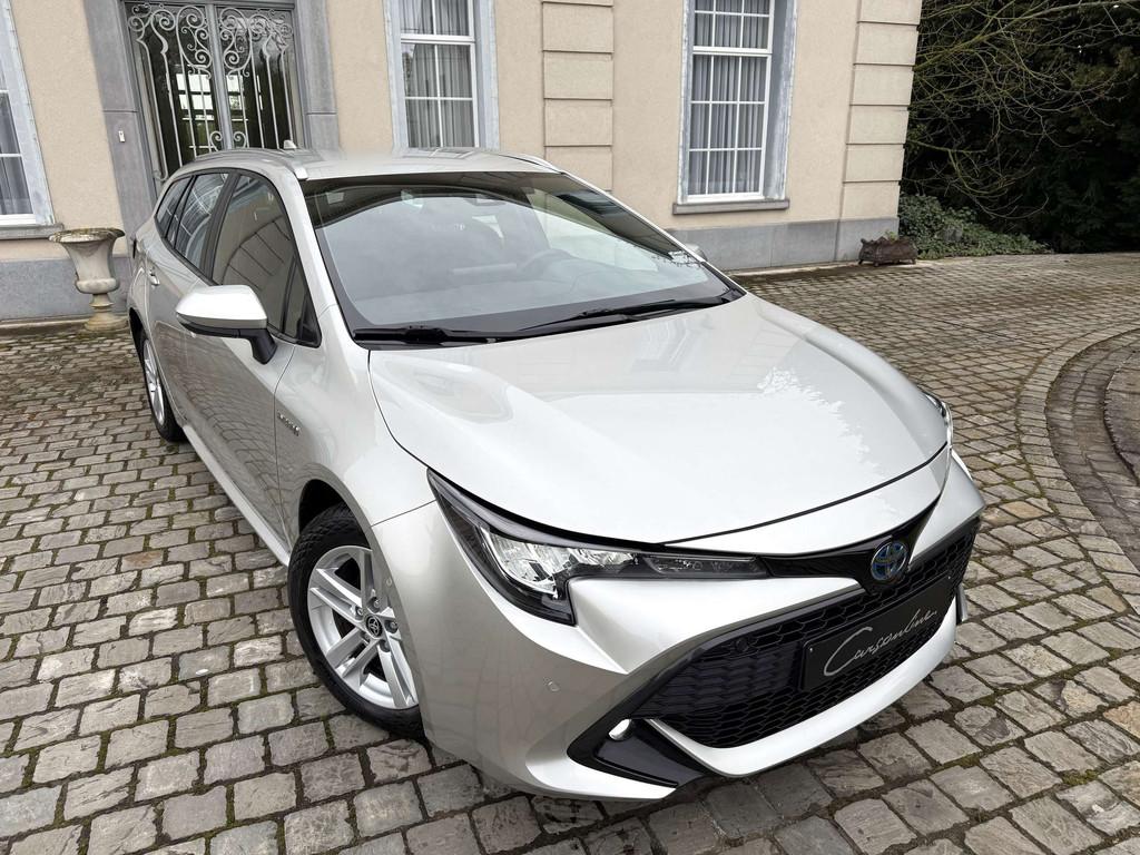 Toyota Corolla SW Hybrid 1.8 Dynamic Plus e-CVT Camera, Gara, Auto's, Automaat, Stof, Gebruikt, Euro 6